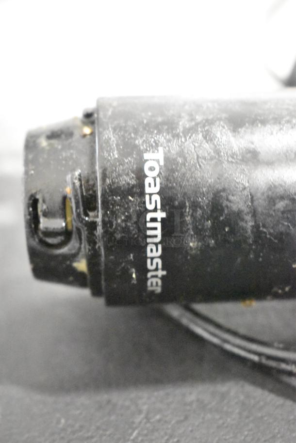 Lot includes a well-used black Toastmaster immersion blender base. Visible wear indicates previous use.