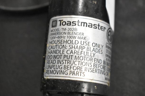Toastmaster immersion blender base, model TM-2021B label, 120V, 100W max; includes safety handling instructions.