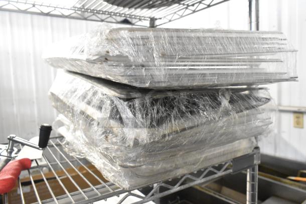 Lot of 3 poly clear lids wrapped in plastic, stacked on metal shelving. New condition with potential industrial use.