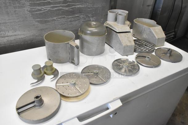 11 various kitchen items including continuous feed head, 2 bowls, 2 S blades, 3 slicing and 3 grating blades.