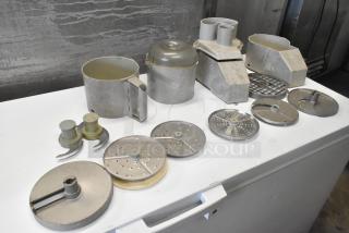 11 various kitchen items including continuous feed head, 2 bowls, 2 S blades, 3 slicing and 3 grating blades.