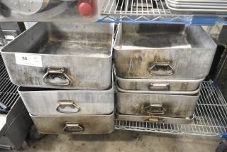 Eight large metal pans with handles, showing signs of wear and aging. Auction label indicates 8 times your bid.