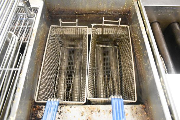 Rustic Pitco Frialator 40D stainless steel commercial deep fat fryer with two metal baskets, natural gas-powered. Model 40D.