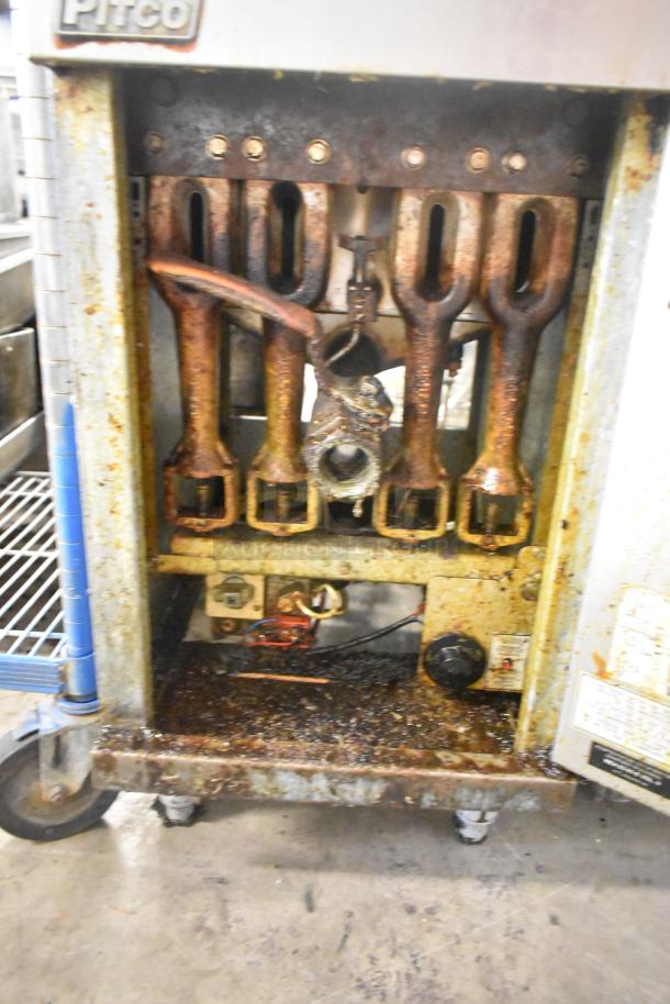 Pitco Frialator 40D natural gas fryer, stainless steel, 115,000 BTU, with visible wear and grime, two metal fry baskets included.