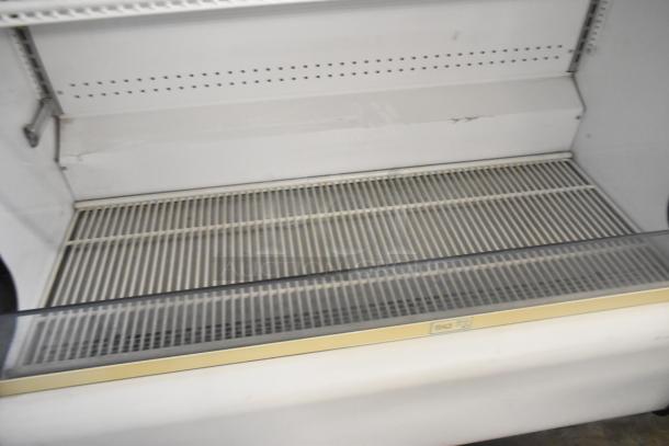 True TAC-48GS-LD Commercial Merchandiser in good condition, metal, open front. 208-230V, 1 Phase. Shelving visible.