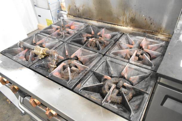 Copper Beech CBR-6 stainless steel 6-burner gas range with oven, over shelf, and back splash on casters. 211,000 BTU.