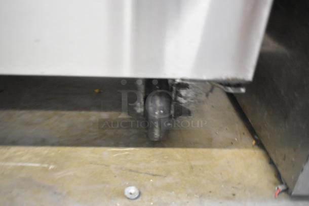 Coldline SMP48 stainless steel commercial prep table with sneeze guard, mounted on commercial casters. 115 Volts, 1 Phase.