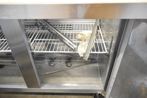 Coldline SMP48 stainless steel prep table with sneeze guard, commercial casters, 115V, 1 phase. Interior shelves visible.