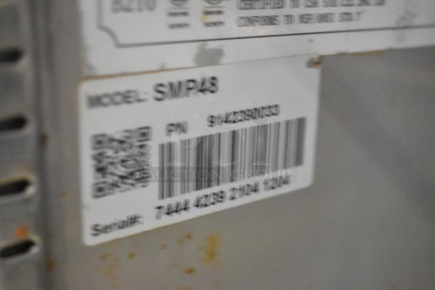 Coldline SMP48 commercial prep table, stainless steel, sneeze guard, on casters. Model: SMP48, 115V, 1 phase. Label with serial number.
