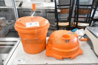 Orange salad spinner and Dynacube vegetable cutter, both with hand cranks, in used condition; auction labels visible.