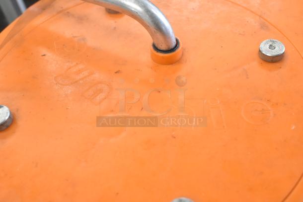 Orange poly items: lettuce spinner and Dynacube vegetable cutter. Visible handle and embossed "Dynamic" marking. Auction set.