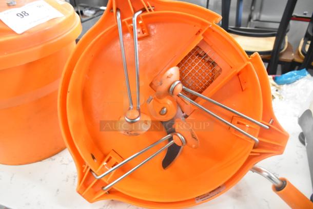 Orange poly lettuce spinner and Dynacube vegetable cutter, both with metal parts, in used condition, labeled with auction tag 98.