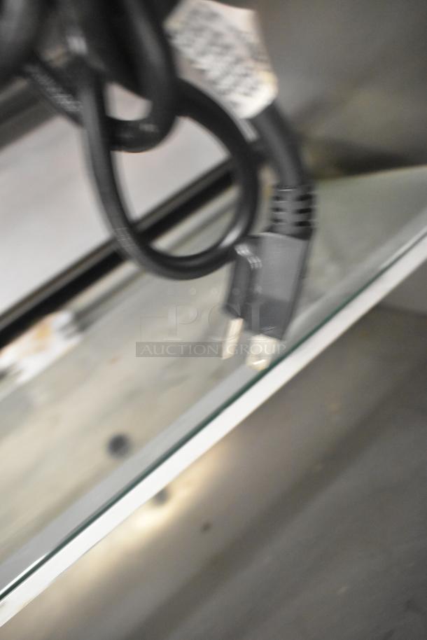 Power cord of 2019 Cooltech CUST-48OFS metal commercial merchandiser, showing plug and part of cord with label.