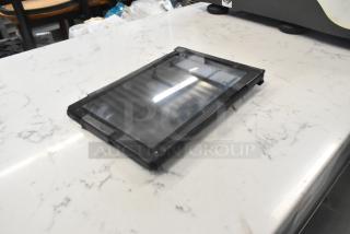 T8 Tablet on countertop, reflective screen, slim black frame, appears in good condition, no visible markings.