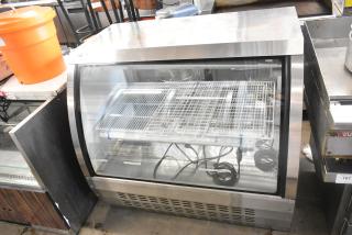 Universal FCI-48 deli display case, 115V, 1 phase, stainless steel, glass front, used condition, interior shelves visible.