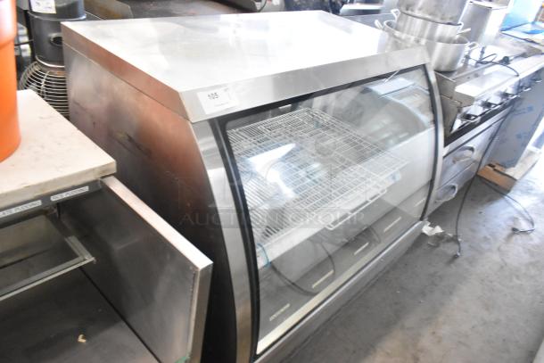 Universal FCI-48 deli display case, metal, floor style, 115V, 1 phase, glass front, shelving visible, commercial use.