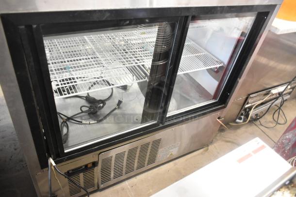 Universal FCI-48 Metal Commercial Deli Display Case, floor style, 115V, 1 phase, shelving visible, minor wear, cables included.