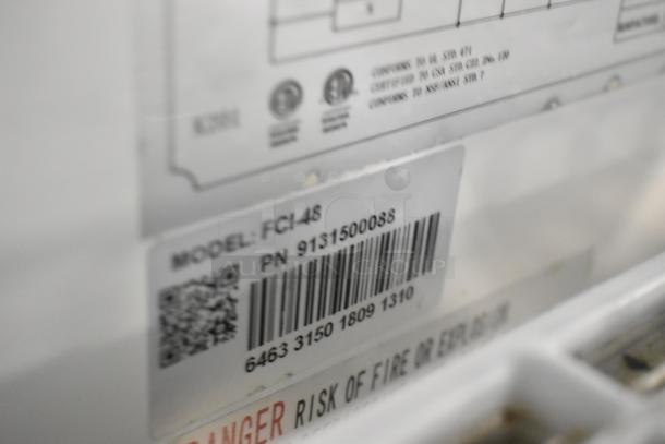 Universal FCI-48 deli display case with model and part number labels, 115V, 1 phase, metal commercial floor style.