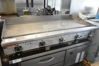 Vulcan stainless steel commercial gas griddle, flat top, thermostatic controls, minor wear, item tags visible.