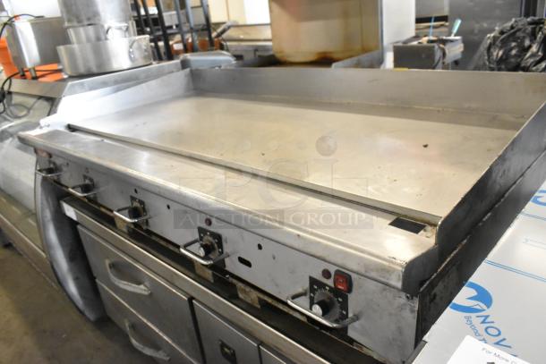 Vulcan stainless steel commercial gas griddle, countertop model, thermostatic controls, good condition, visible knobs.