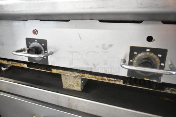 Vulcan stainless steel commercial gas griddle with thermostatic controls, visible wear, handles, and temperature dials.