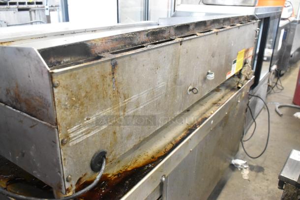 Vulcan stainless steel countertop gas griddle with thermostatic controls, showing signs of wear.