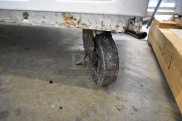 Beverage Air WTRCS52-1-60 chef base caster with noticeable wear and dirt, on a commercial floor.