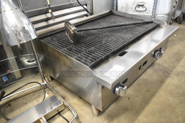 Migali stainless steel commercial countertop gas charbroiler grill, dual knobs, used condition, visible markings on front.