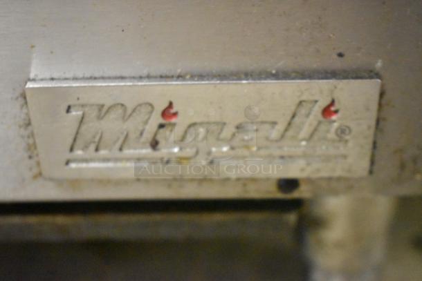 Migali stainless steel gas charbroiler grill, commercial countertop model, features brand logo plate, showing slight wear.