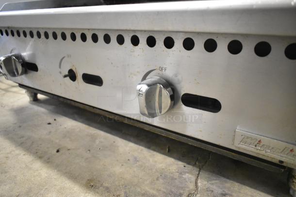 Migali stainless steel countertop gas charbroiler grill, featuring control knobs and branding. Used condition, functional.