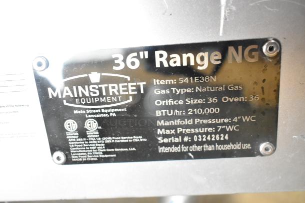 Mainstreet 541E36N stainless steel 36" range tag showing it is natural gas powered, 210,000 BTU for commercial use.