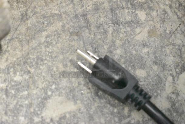 Close-up of a black power plug for the Avantco 177CO14 convection oven, showing a standard three-prong configuration.