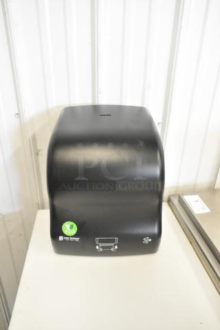 San Jamar black poly paper towel dispenser, brand new with minor scratches, eco-friendly label visible.