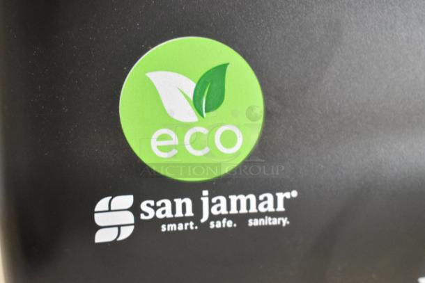 Brand new San Jamar black poly paper towel dispenser with eco-friendly label. Scratch and dent condition.