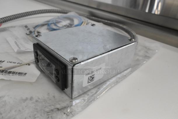 Brand new Delfield 000-282-00HB-S control kit, shiny metal casing, slight scratches. Label: "000-282-00HB."