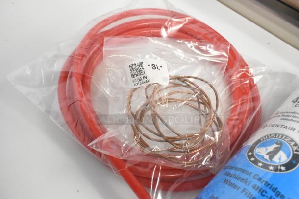 2 brand new scratch and dent items: Hoshizaki 4HC-H water filter cartridge and Catchall C-032 filter drier, with packaging.