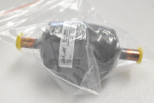New Catchall C-032 filter drier in packaging, marked for refrigerant systems, part of auction with Hoshizaki water filter.