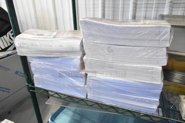 Nine bundles of Choice 999948 guest checks, brand new with light scratches, wrapped in plastic, on a shelf.