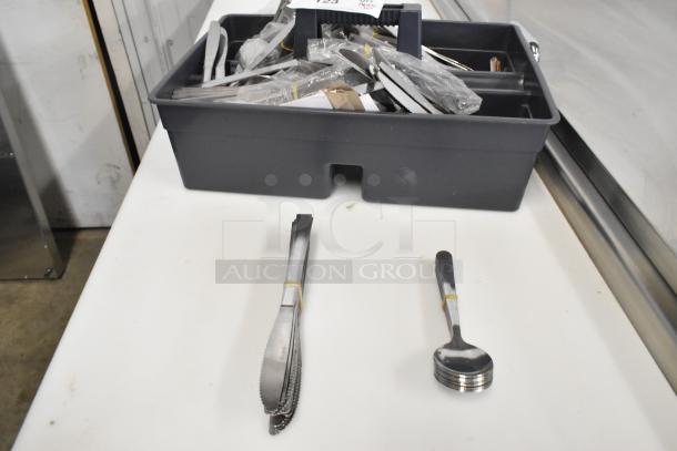 10 bundles of 12 new scratch and dent silverware, including butter knives and spoons. Packaged in a gray tray.