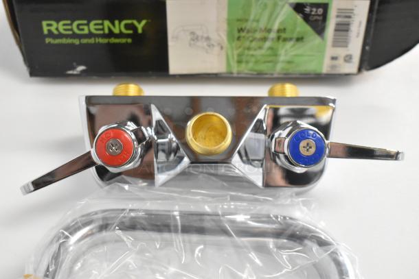 BRAND NEW Regency 600FW46 wall mount faucet with 6" swing spout, 4" centers. Slight scratches, hot/cold labels visible.