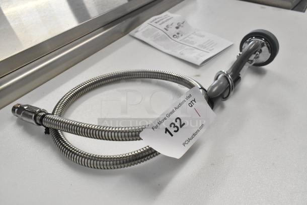 Brand new Choice T&S spray nozzle with coiled stainless steel hose. Minor scratches noted, labeled auction item 132.