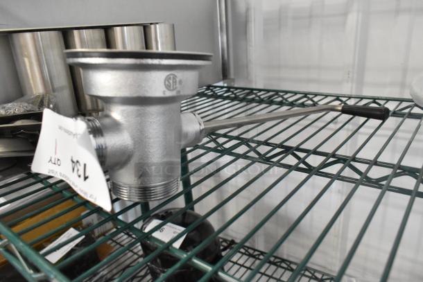 Brand new T&S metal drain by Choice on shelf, slight scratch and dent, includes threaded fittings and lever.