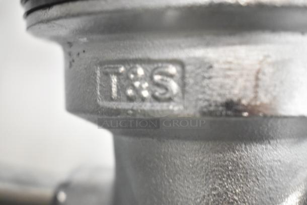 Choice T&S metal drain, brand new with scratch and dent. Visible "T&S" logo marking.