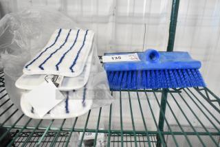 4 new Lavex 24" microfiber mop pads and blue brush head on a shelf; tags indicate "135" and "QTY 4".