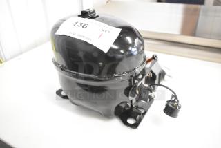 BRAND NEW SCRATCH AND DENT Cubigel NUT70NR Compressor, 115-127 Volts, 1 Phase, Choice. Auction label visible.