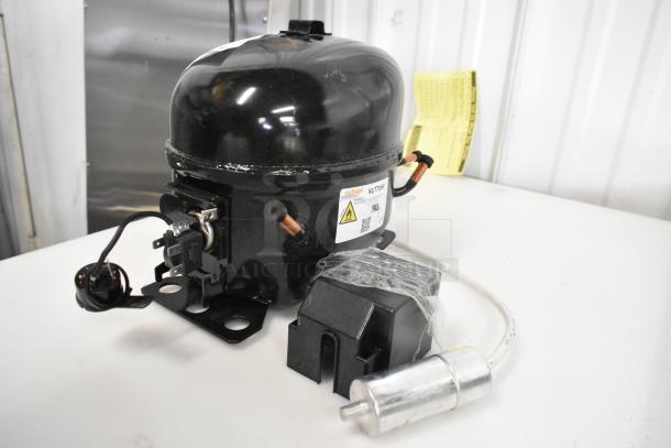 BRAND NEW Cubigel NUT70NR Compressor, 115-127V, 1 Phase, Choice. Minor scratches. Labels for voltage and phase visible.