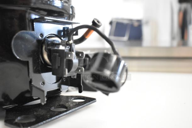 Brand new Cubigel NUT70NR compressor by Choice, 115-127V, 1 Phase, with visible scratches and dents.