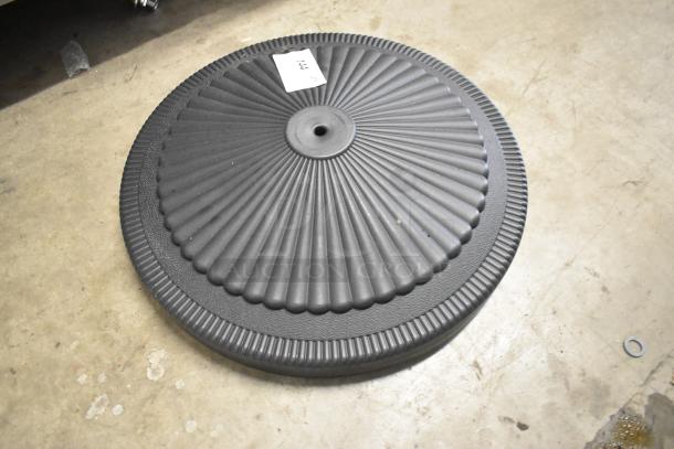 "Choice black umbrella base, brand new, features scratch and dent, grooved circular design, labeled with '141'."