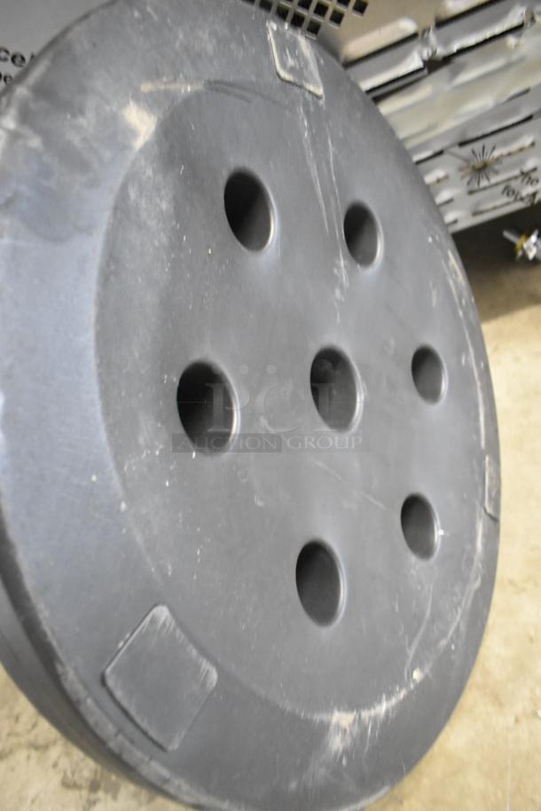 Brand new Choice black umbrella base, scratch and dent condition, round design with holes, durable material.