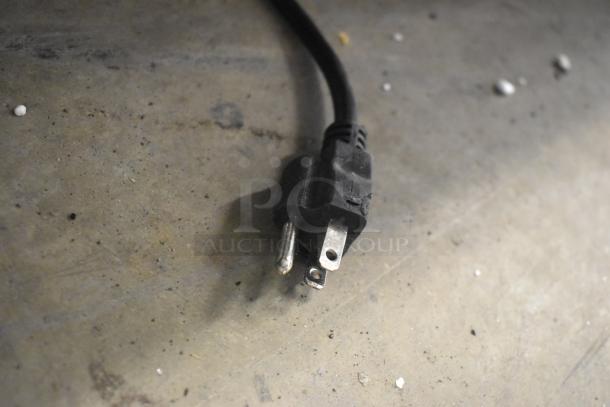 Close-up of a power plug for the ServIt 423HSW2060 Stainless Steel Heated Shelf Warmer, showing standard prongs.